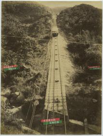 1890年代香港山顶缆车大幅蛋白老照片一张。26.6X20.3厘米。香港开埠初期，往来太平山至中环的主要交通工具为轿。1881年6月13日，立法局议员伍廷芳率先提议在香港岛兴建电车系统，1888年5月30日开通运行。