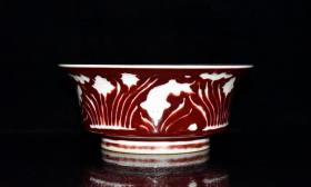 明代宣德霁红留白雕刻鱼草纹折腰碗