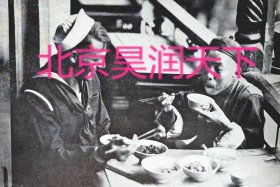 一个美国士兵和一个中国绅士一起吃饭学着使用筷子