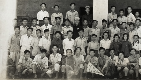 老照片：广东梅州，1950年，梅县第一届暑期青年学团一宣队合影，三角旗上有“梅县青年学团夏征宣传队第一队”，背景建筑有“暑期学团办公厅”字样。背题：杨钦澄，印章。——简介：杨钦澄，广东梅县人，1956年华中工学院毕业。北京第二机床厂数控精密机床研究所副所长。（妻子）傅锦芳，奉贤人，56年第一机械工业部南京机器制造学校毕业。【广东梅州中学－武汉华中工学院－北京第二机床厂研究所副所长－杨钦澄旧藏系列】