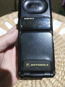 【故障机需要维修，配件机老式模拟机】上世纪九十年代有钱人家使用过的二哥大模拟手机一部 MOTOROLA摩托罗拉 MICRO TAC Ⅱ【配有电池一块】机器不能点亮，外观使用磨损严重，两侧小角有撞击破损，键盘星号键上有小的破损，机内标签不在，无天线，翻盖有小的破损【图片我实拍，品相以图片为准】本商品仅作为配件机或是影视道具摆件出售，不能正常使用