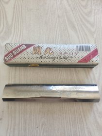 一把上海国光口琴厂有限公司制造的国光牌回声口琴。口吹乐器，带盒。