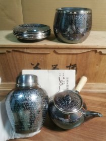 银川堂黄铜鎏银茶具套，一只铜壶，一只茶叶罐，一只建水，五片茶托盘，全新未使用品，有原装盒子，贡布和陶历，看好拍不讲价退换。 侧把壶：口径7.3厘米，肚径10cm，高度8.4cm，重量213克，容量400毫升。 建水：口径9.5，肚径11.0cm，高度8.2cm，重量236克，容量530毫升。 茶筒：直径10cm，高度12.8cm，重量288克。 茶托：直径11cm，高度1.8cm。重量352克。