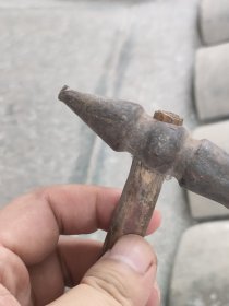 出一把银匠古董锤子，具有复古的韵味和历史感。锤头部分由金属制成，表面略显磨损，颜色呈深褐色，手柄部分为木制，结实耐用。此锤子适合收藏或作为道具使用，可增添家居的艺术氛围。