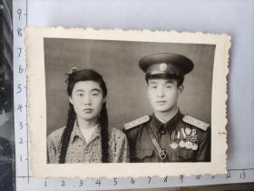 中国人民解放军着55式中尉军装佩戴至少六枚勋章与粗辫子美女合影照片(郭健相册)