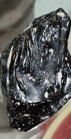 纯天然玻璃陨石，有熔壳气印流纹，有拉长气泡，特征明显，无磁性，有压手感，打光不透，重0.21斤（105克）。