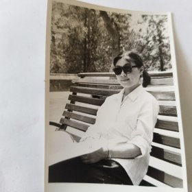 1980年5月，美女戴着墨镜在长椅上前留影照片