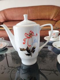 唐山第五瓷厂白兰牌手绘雕金加彩茶具一套。七十年代出口瓷，画工典雅，瓷质洁白如玉（精选福建德化瓷土），薄胎透明，手绘雕金加彩，做工极其精美。唐山第五瓷厂白兰牌手绘雕金加彩薄胎高档10件套茶具一组。一套有：茶壶一把，茶杯四个，碟五个。带七十年代原包装，全新未使用。 白兰牌瓷器是当时唐山瓷厂四朵金花之一。享誉国内外。手绘雕金加彩是六十年代唐山瓷厂首创，名家作品曾被国外皇室和人民大会堂收藏。顺丰快递包邮。