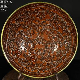 宋代定窑酱釉花卉纹镶边工艺碗。