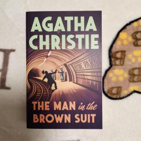 The man in the brown suit