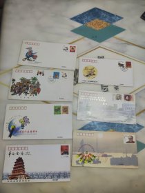 首日封拜年封纪念封共7个合售 己卯年丁丑年特种邮票首日封，1999年拜年封，南京经济广播电台开播10周年、华西金塔参观纪念、南京市第十四次代表大会、纪念孙中山先生诞生一百三十周年铜像揭幕 纪念封 贴邮票 T146 J182等