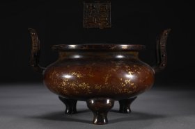 明 精铸铜胎点金洒金朝冠耳炉 【规格】高13.4cm 口径16.6cm 腹径17.8cm 耳距21.4cm 重3.3公斤 【款识】宣德年制 【详述】 炉形仿自上古青铜鼎，古韵犹存，形制圆浑规整，鼓腹扁圆，肩部对称出双朝冠耳，冲天而立，挺拔之至，婉转流动，底承三兽足，落地沉稳，敦实有力。腹部两金斑遍布，如雪花飘落，自然洒脱。整器造型端庄，包浆醇厚，典雅柔美，可见匠心。朝冠耳式样亦称判