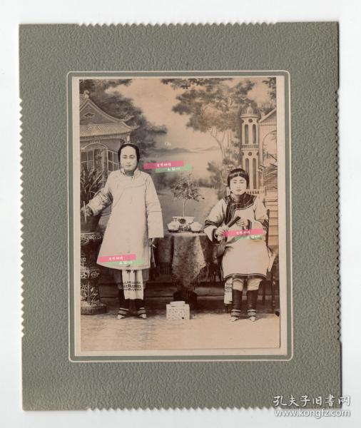清末或民国双胞胎女子合影，一位站姿，手拿香烟，一位坐姿，手拿扇子。小脚明显，照片为影楼照。照片尺寸长12厘米 宽9厘米 带卡纸尺寸长17厘米，宽14厘米。