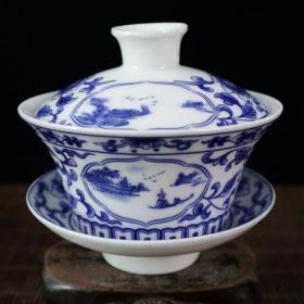 青花双面开窗山水图纹盖碗
高10.5cm底径12cm杯7.3x12.3cm